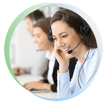 Woman receptionist smiles while listening to a phone call on a headset.